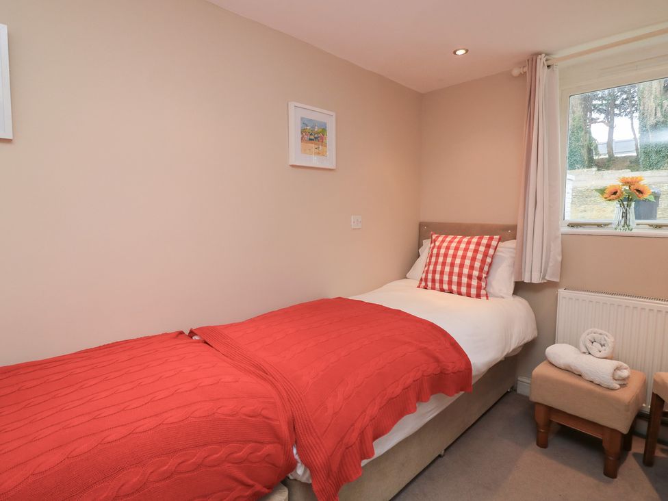 A bedroom with a single bed and a window at Lanapoule in Salcombe