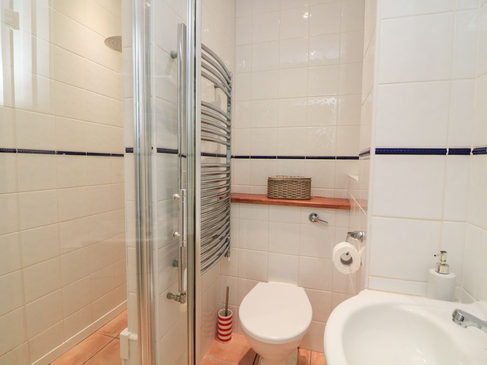 A bathroom with a shower, toilet, and sink at Lanapoule in Salcombe