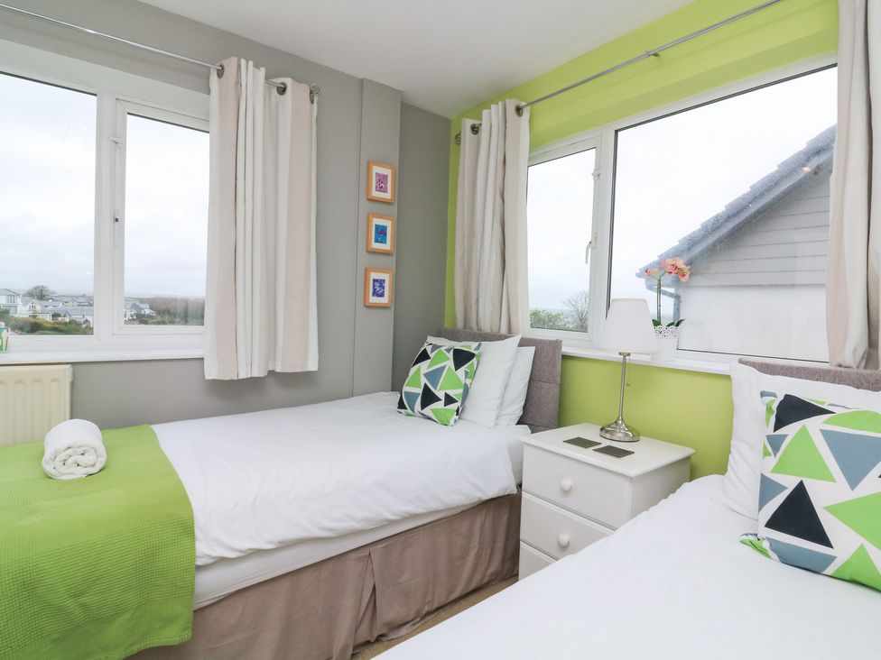A bedroom with two beds and a window at Lanapoule Salcombe