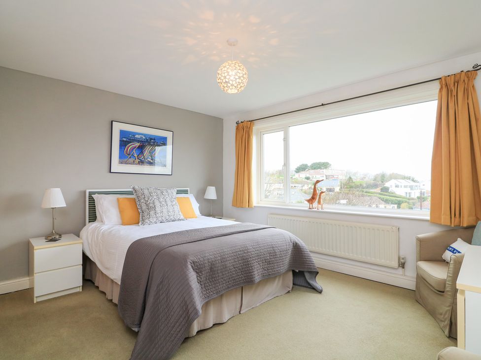 A bedroom with a bed and window at Lanapoule in Salcombe