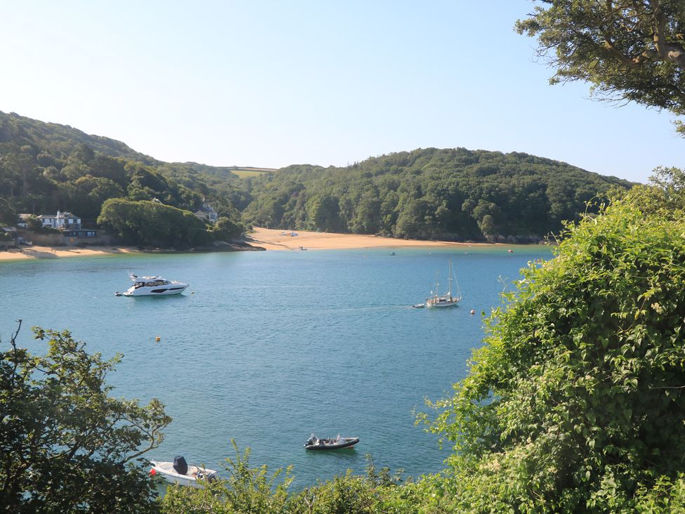 A view of boats on water with trees in the background at Lanapoule Salcombe