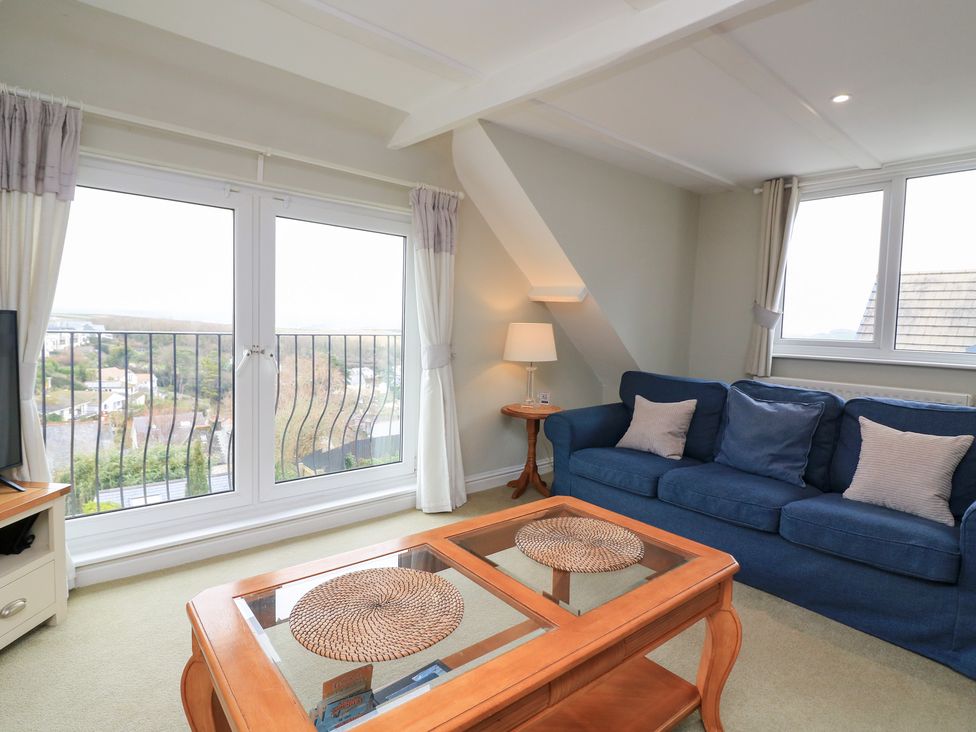 A living room with a sofa and coffee table at Lanapoule in Salcombe
