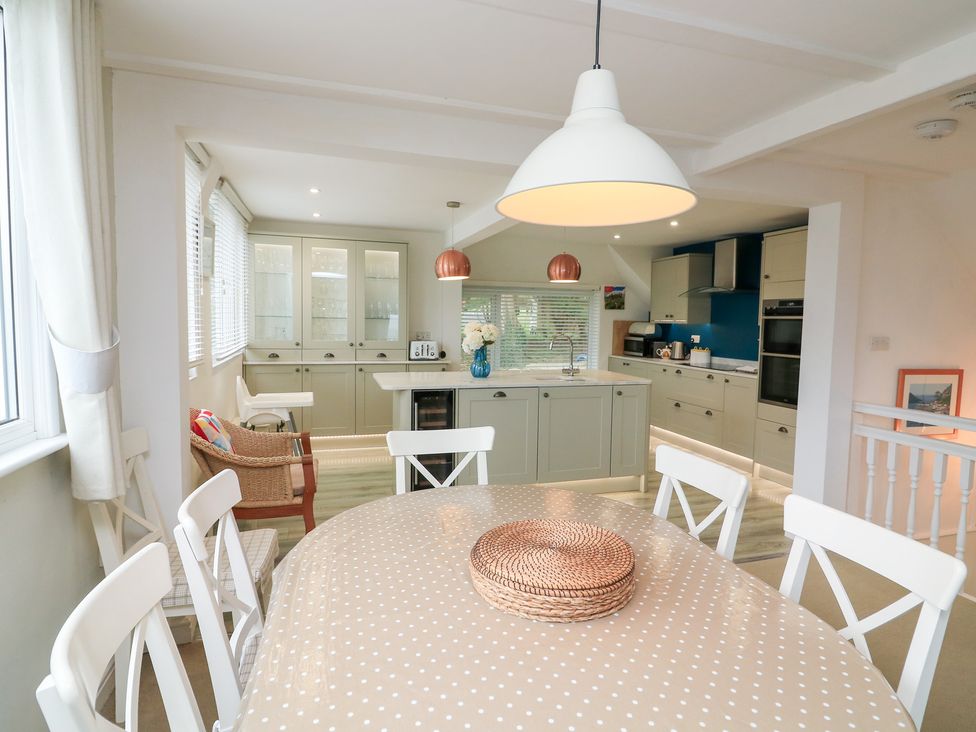 A kitchen with a dining table and chairs at Lanapoule Salcombe