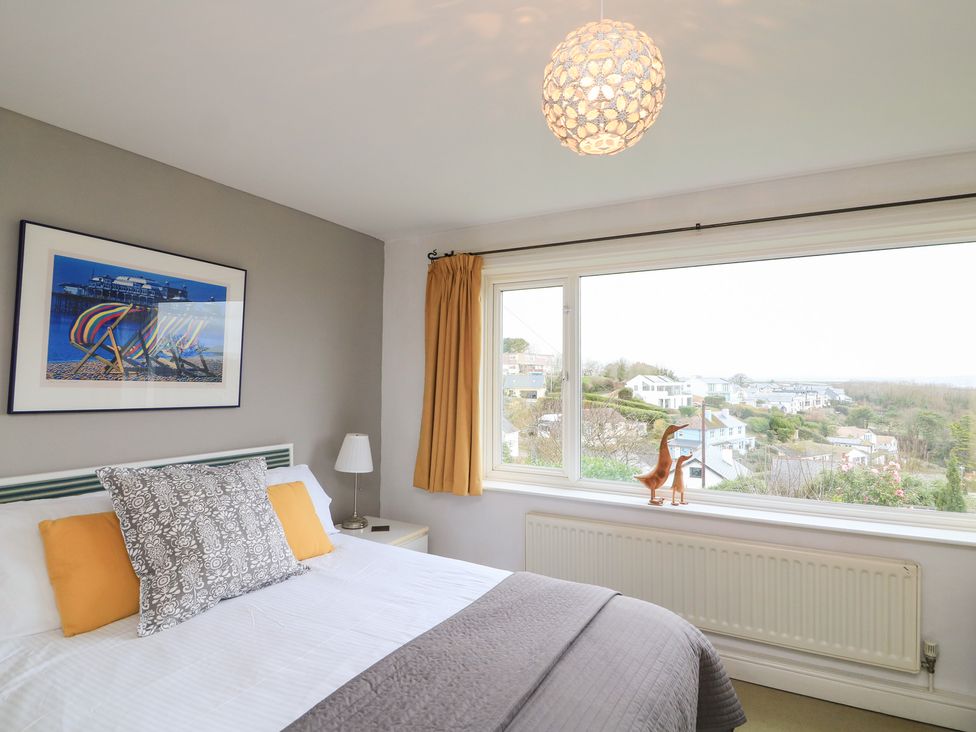 A bedroom with a bed and a view at Lanapoule in Salcombe