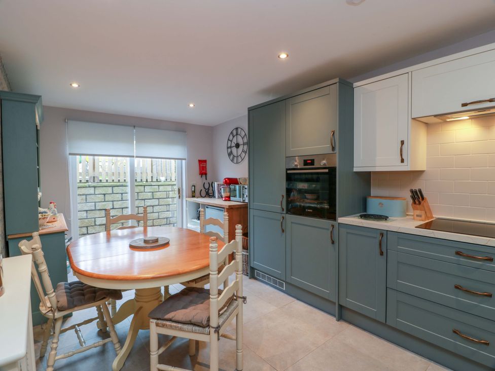 A kitchen with a dining table and chairs at Spring Cottage in Chirnside