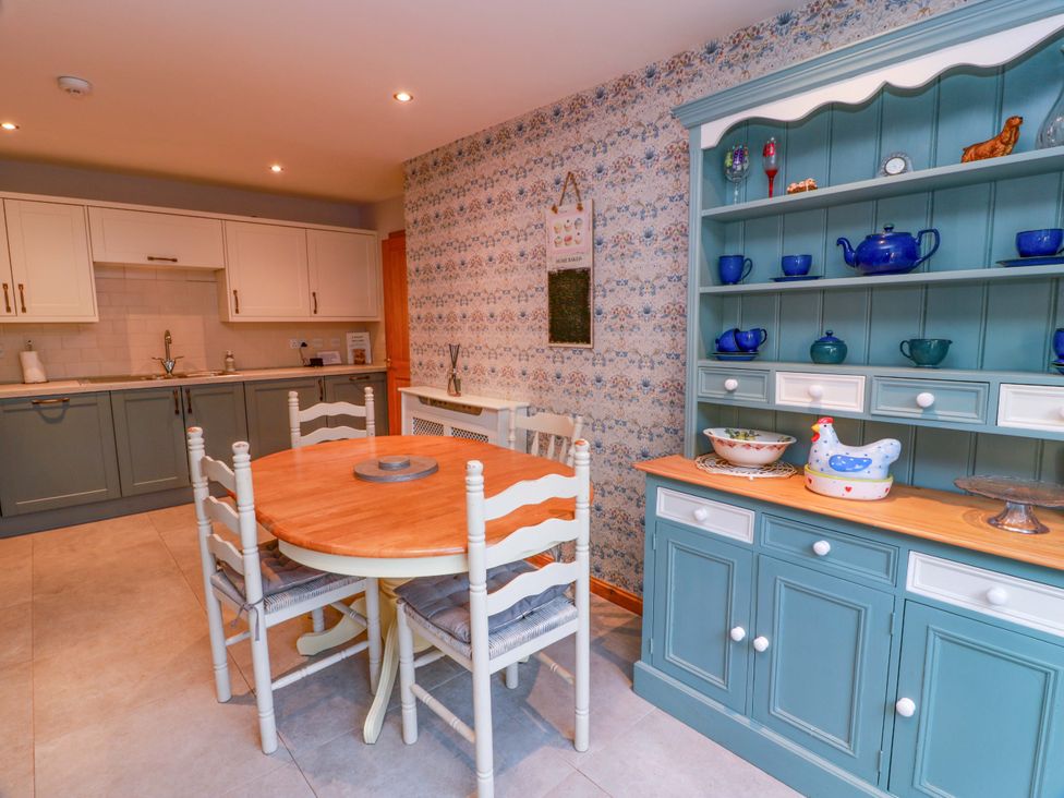 A kitchen with a table and chairs at Spring Cottage in Chirnside