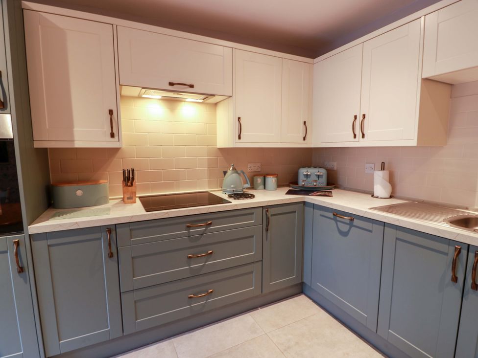 A kitchen with cabinets and appliances at Spring Cottage in Chirnside