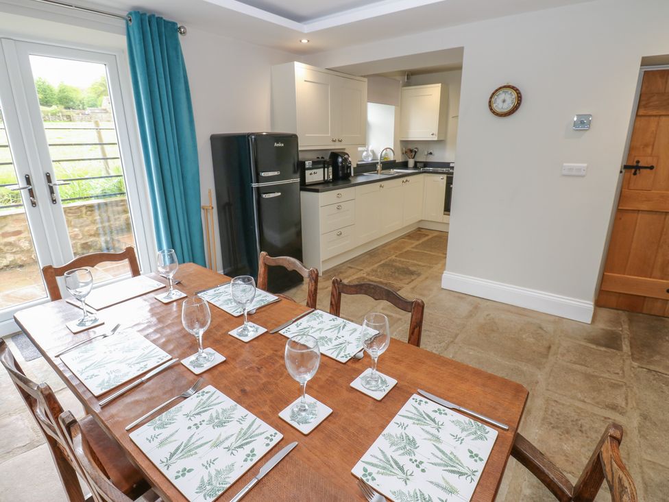 A dining room with a table and chairs at White Lea in Reeth