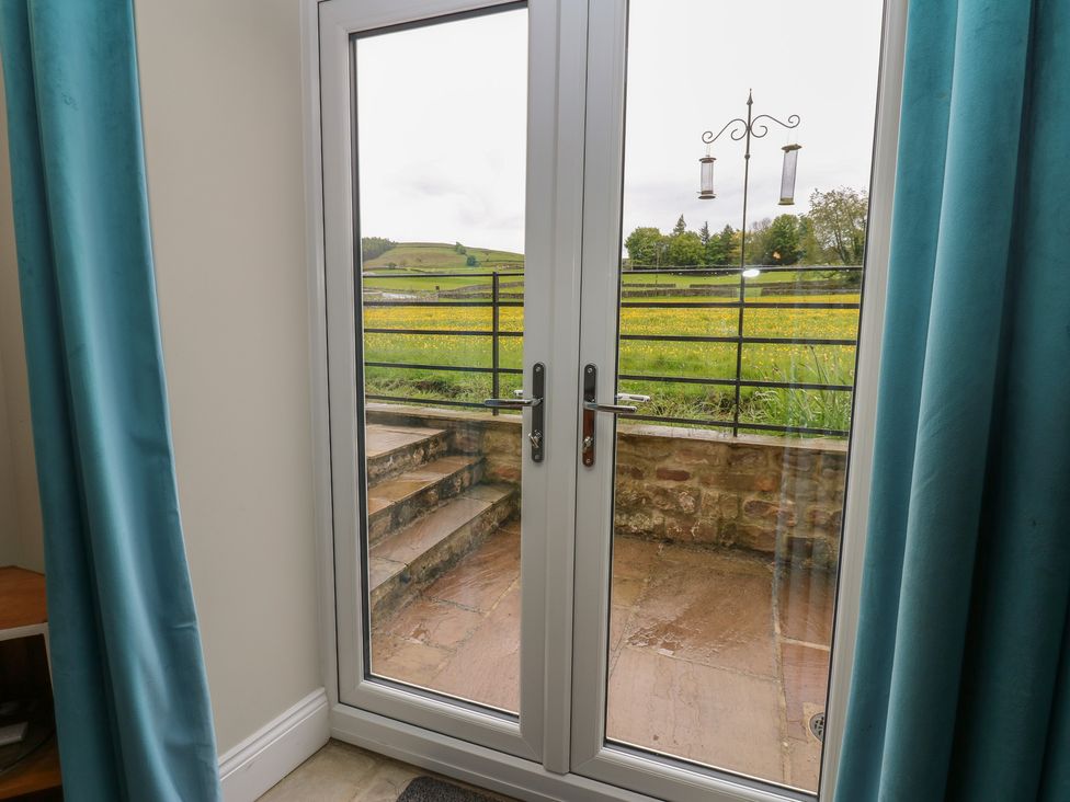 A view through sliding doors with steps and railings at White Lea in Reeth