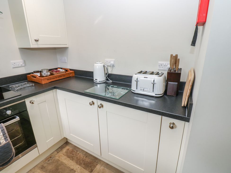 A kitchen with a toaster and kettle on the countertop at White Lea in Reeth