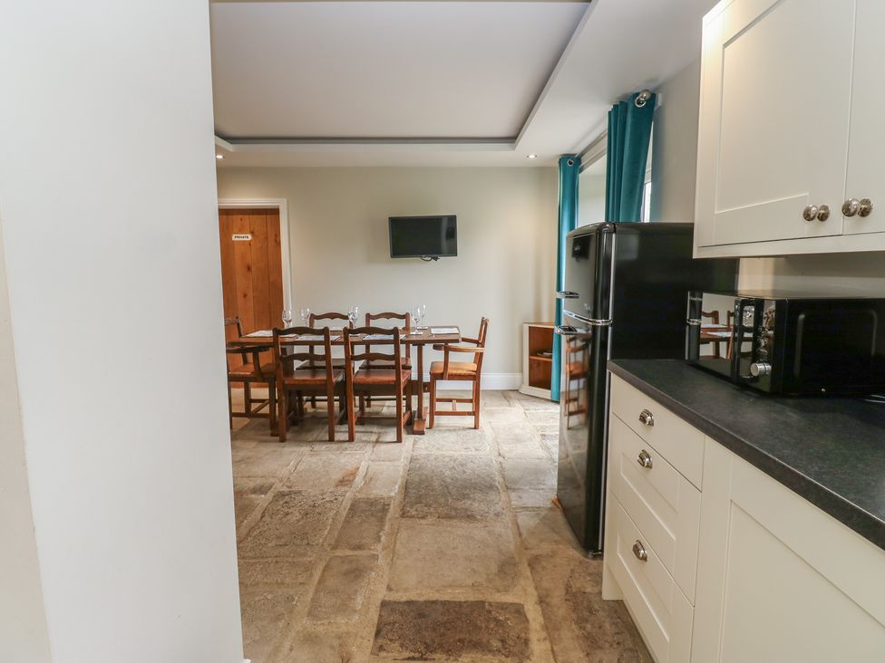 A kitchen with a dining table and chairs at White Lea in Reeth