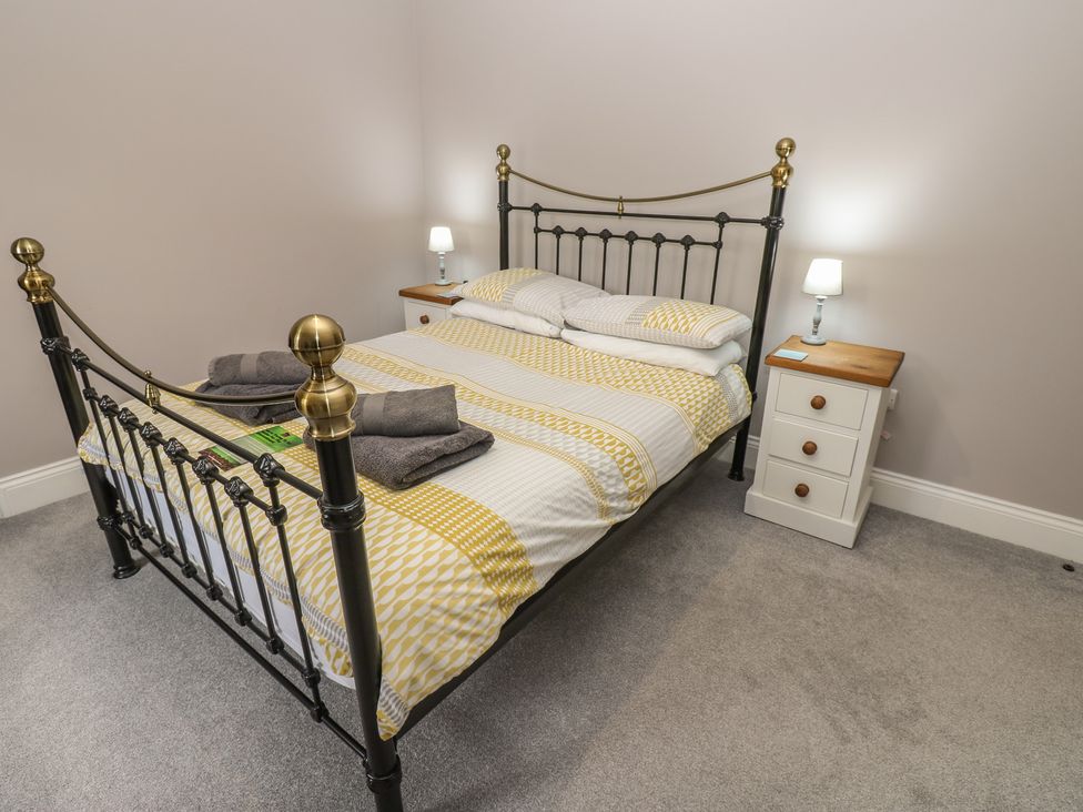 A bedroom with a bed and nightstand at White Lea in Reeth