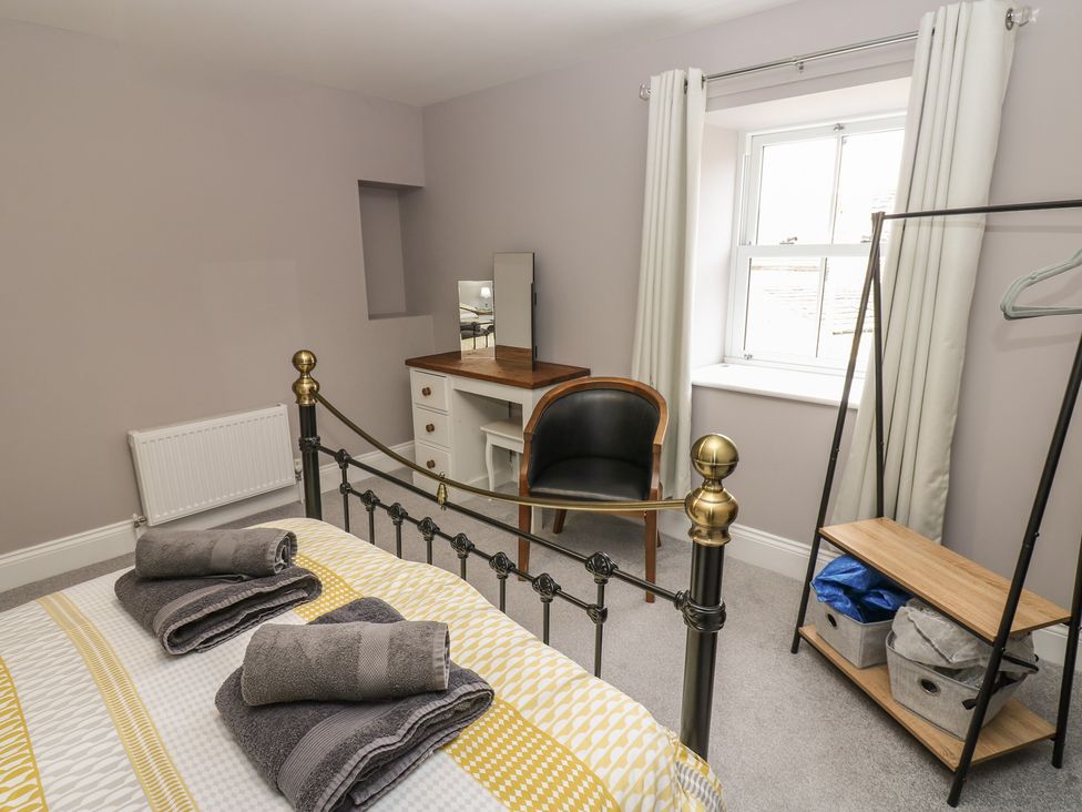 A bedroom with a bed and desk at White Lea in Reeth