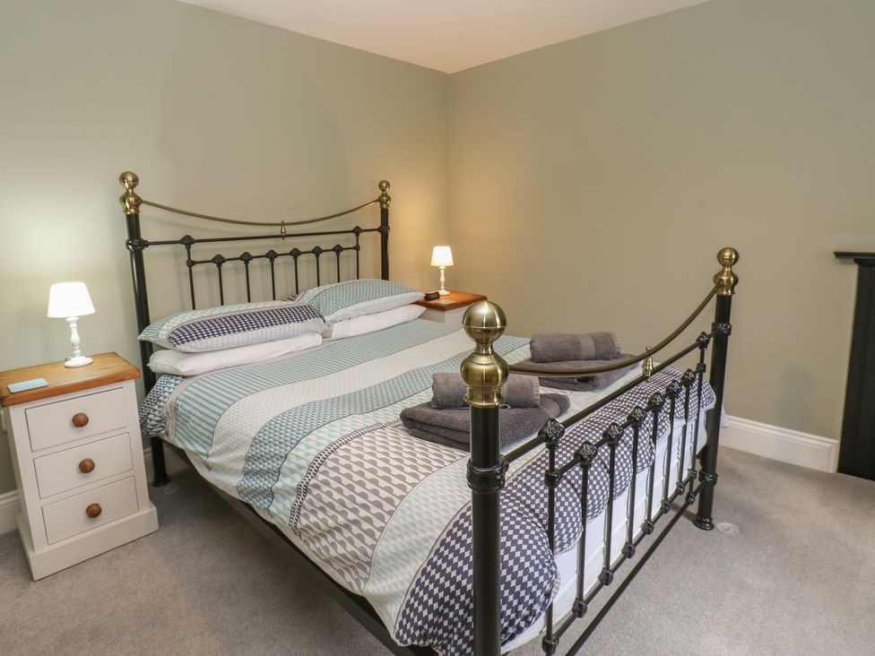 A bedroom with a bed and nightstand at White Lea in Reeth