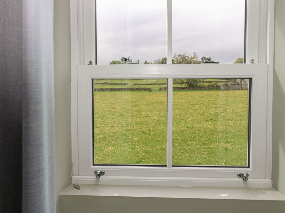 A window with a view of a field at White Lea in Reeth