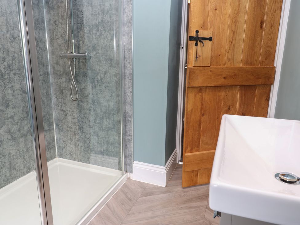 A bathroom with a shower and sink at White Lea in Reeth