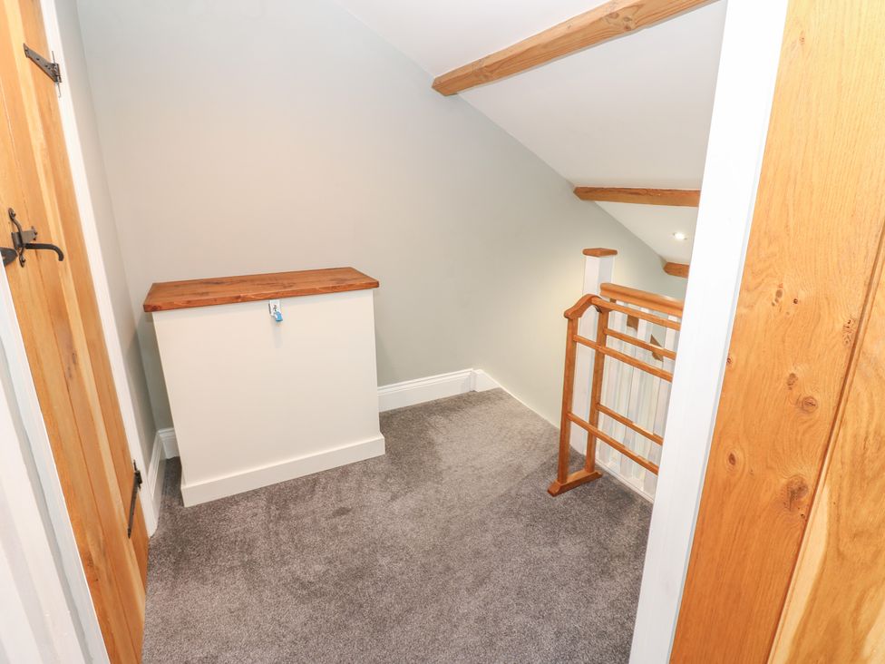 A landing area with a staircase and storage box at White Lea in Reeth