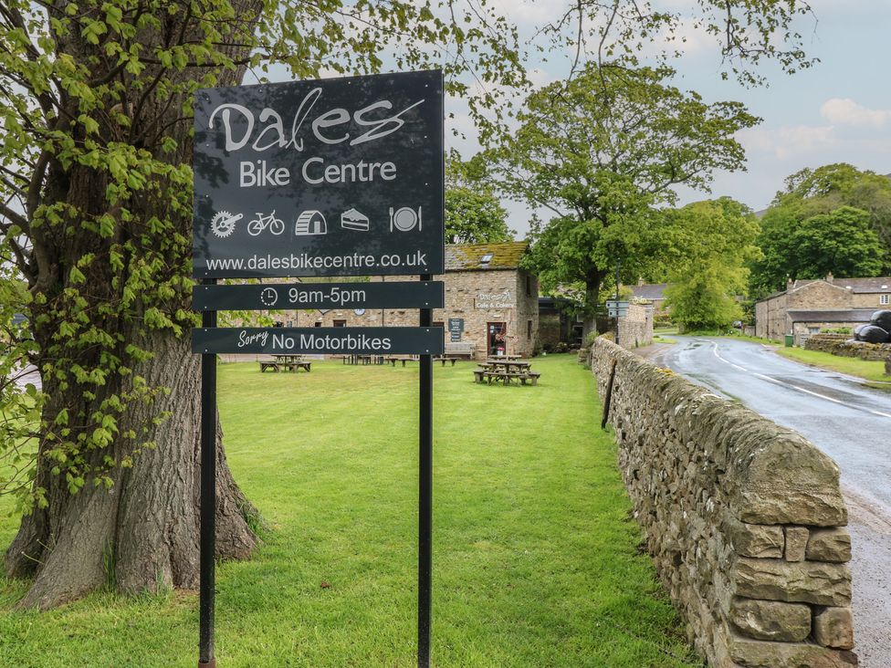 A sign for Dales Bike Centre beside a road in Reeth