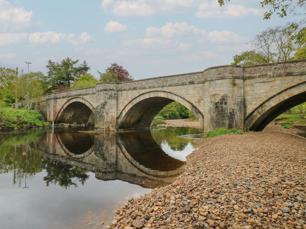 A bridge over a river with reflections at White Lea in Reeth