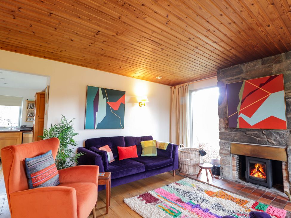 A living room with a sofa and armchair at Inshcraig in Kincraig near Aviemore