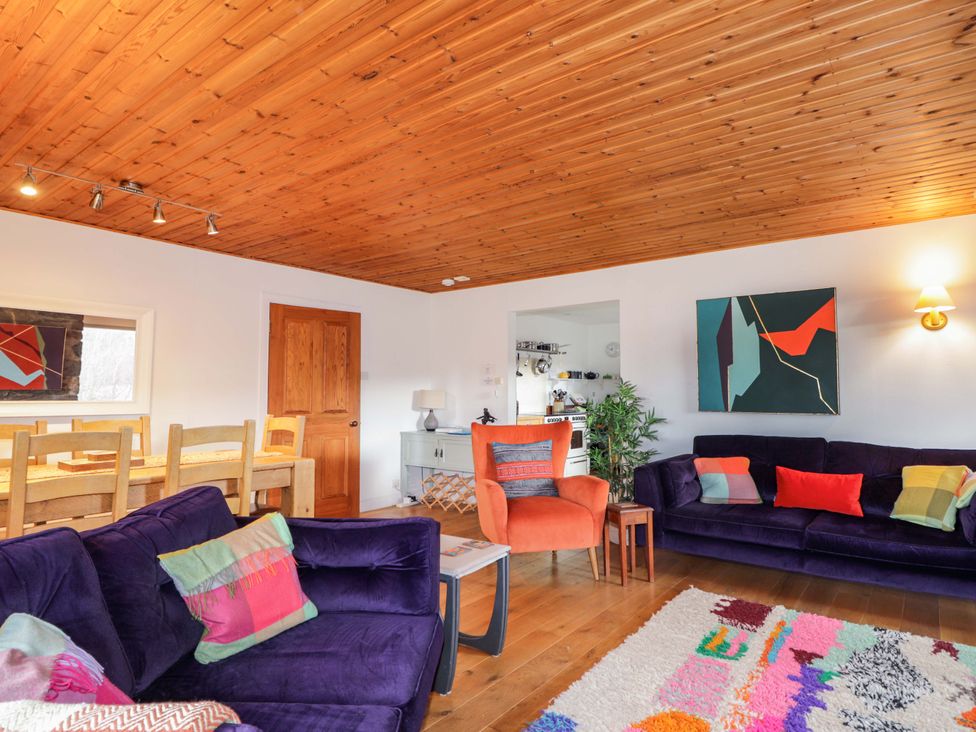 A living room with a sofa and dining table at Inshcraig in Kincraig near Aviemore