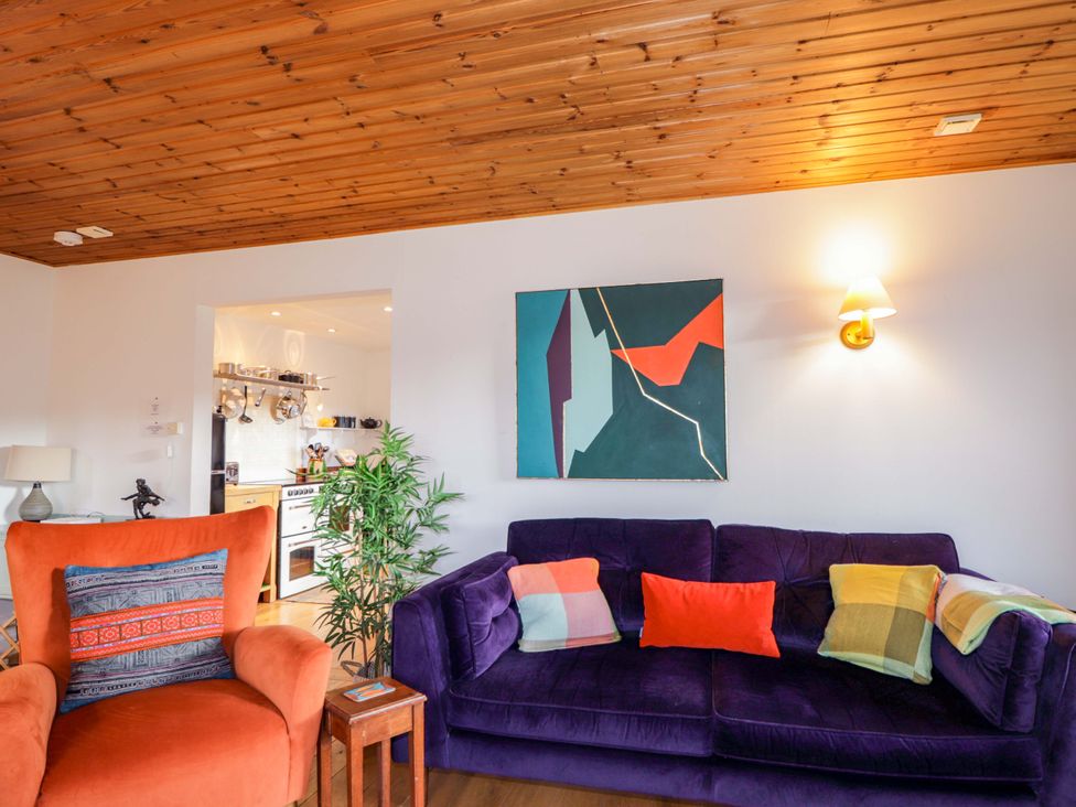 A living room with a sofa and armchair at Inshcraig in Kincraig near Aviemore