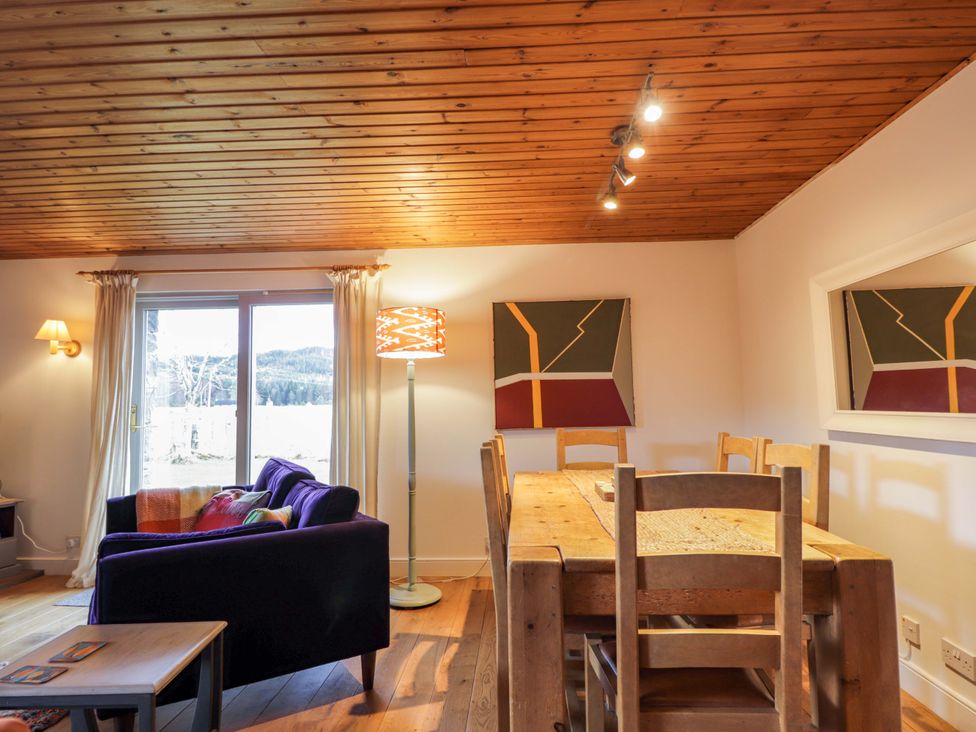 A dining room with a table and chairs at Inshcraig in Kincraig near Aviemore