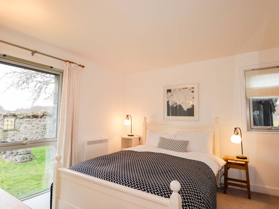A bedroom with a bed and a window view at Inshcraig Kincraig near Aviemore