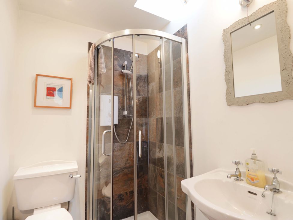 A bathroom with a shower, toilet, and sink at Inshcraig in Kincraig near Aviemore