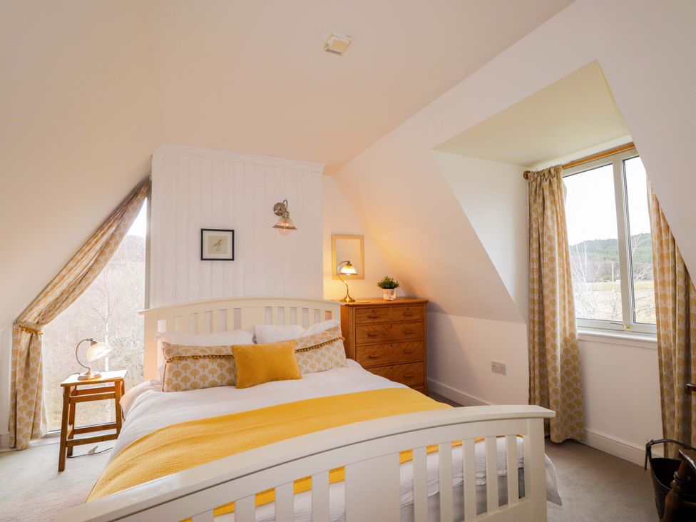 A bedroom with a bed and a chest of drawers at Inshcraig in Kincraig near Aviemore