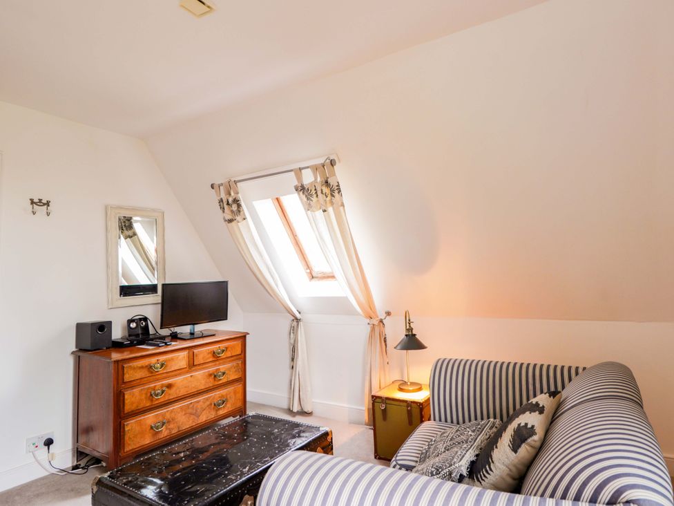 A bedroom with a television and chest of drawers at Inshcraig in Kincraig near Aviemore