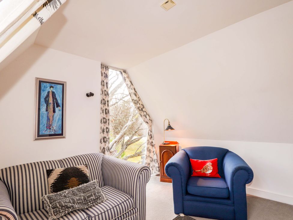 A living room with a sofa and an armchair at Inshcraig Kincraig near Aviemore