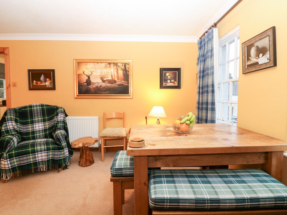 A dining room with a table and fruit bowl at 1 The Cross Dunkeld