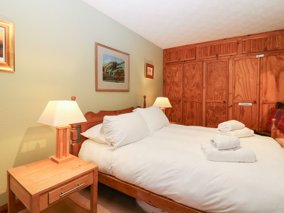 A bedroom with a bed and nightstand at 1 The Cross Dunkeld
