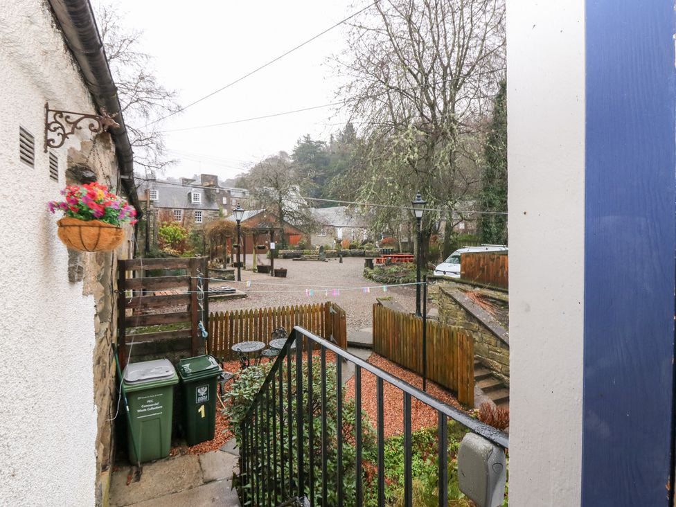 An outdoor area with bins, stairs and a flower pot at 1 The Cross in Dunkeld