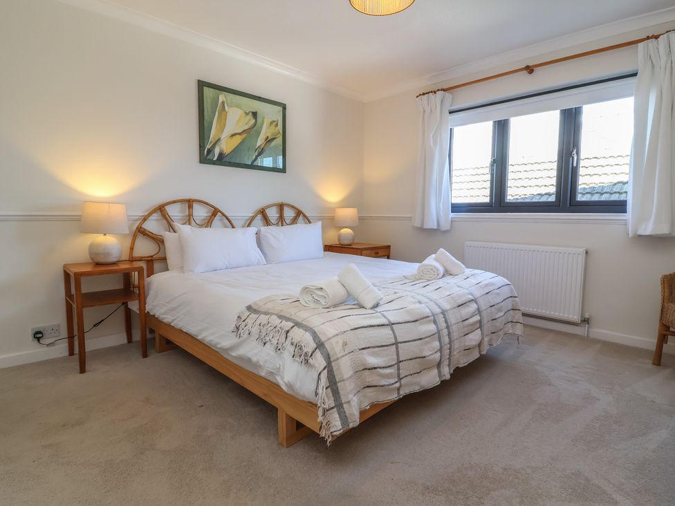 A bedroom with a bed and bedside tables at Auverne Poundstock near Widemouth Bay
