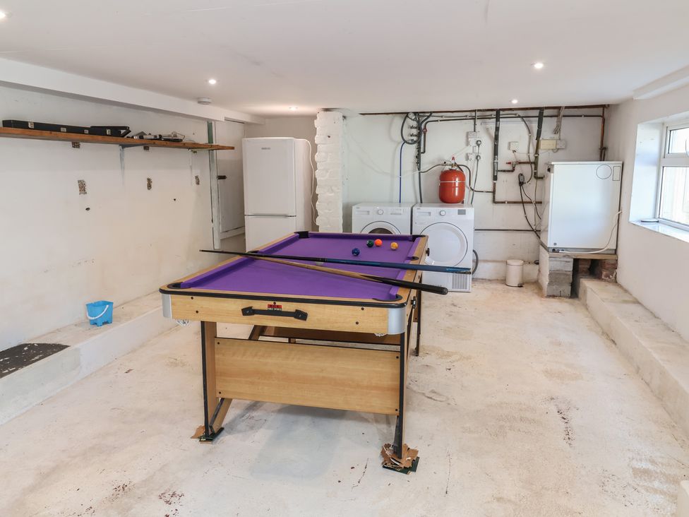 A game room with a pool table and washing machines at Auverne Poundstock near Widemouth Bay