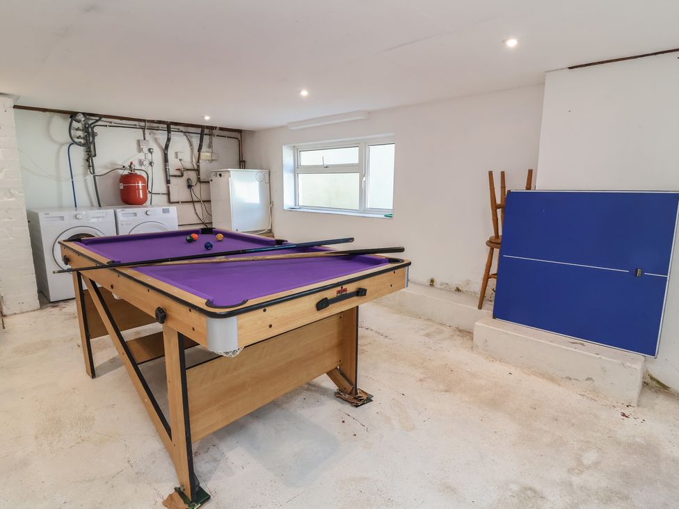A game room with a pool table and washing machine at Auverne Poundstock near Widemouth Bay