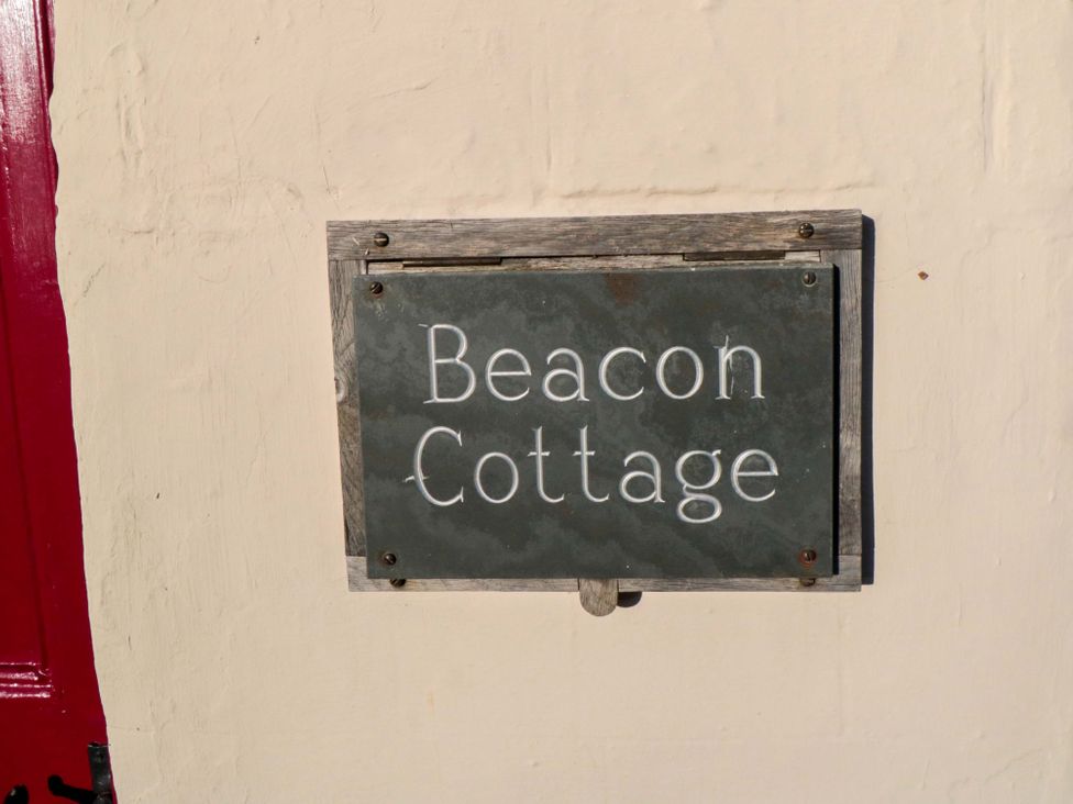 A sign displaying the name Beacon Cottage in Pickering