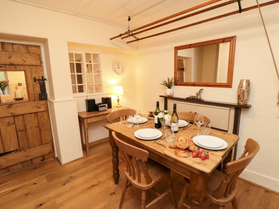 A dining room with a table set for meals at Beacon Cottage in Pickering