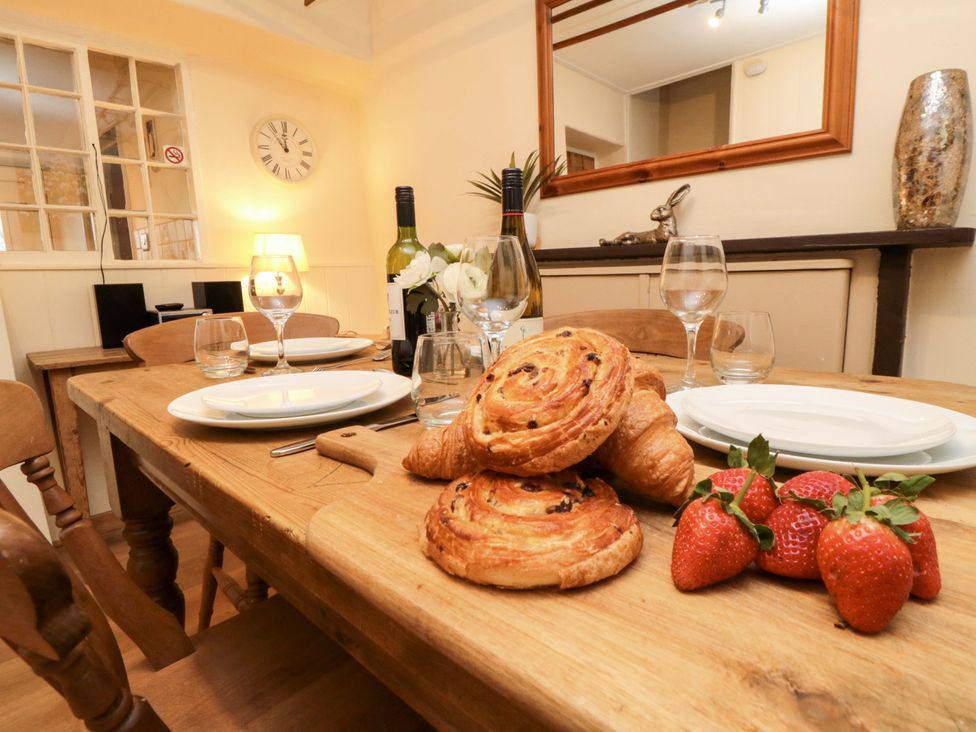 A dining room setup with a table and chairs at Beacon Cottage in Pickering