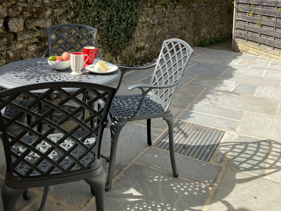 A table with fruit and drinks in an outdoor area at Beacon Cottage in Pickering