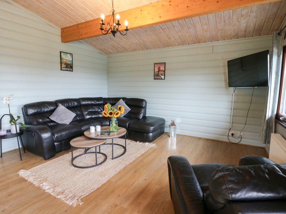A living room with a sofa and coffee table at Mountain View in Rhayader