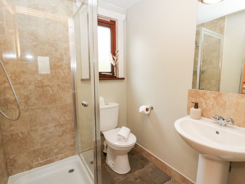 A bathroom with a shower, toilet, and sink at Mountain View in Rhayader