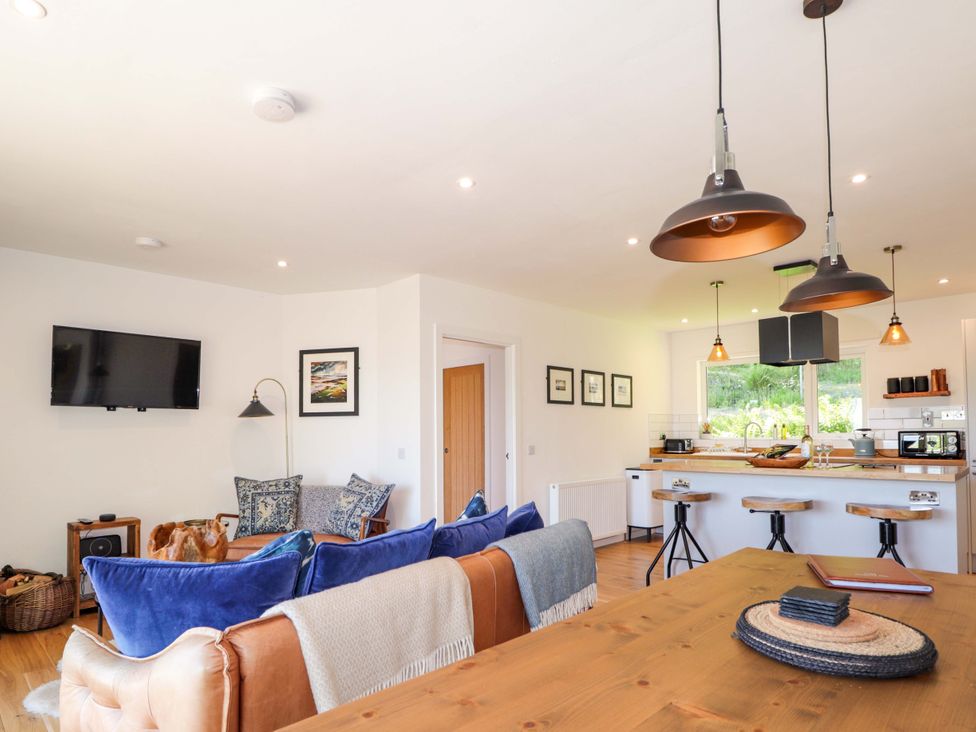 A living room with a sofa and television at The Lookout in Saasaig near Broadford