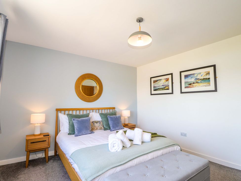 A bedroom with a bed and decorative items at The Lookout in Saasaig near Broadford