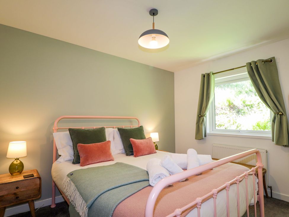 A bedroom with a bed and a window at The Lookout in Saasaig near Broadford