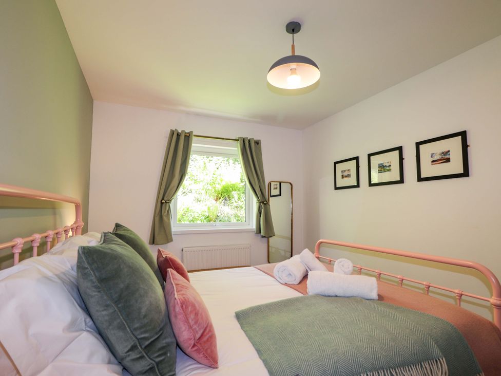 A bedroom with a bed and window at The Lookout in Saasaig near Broadford