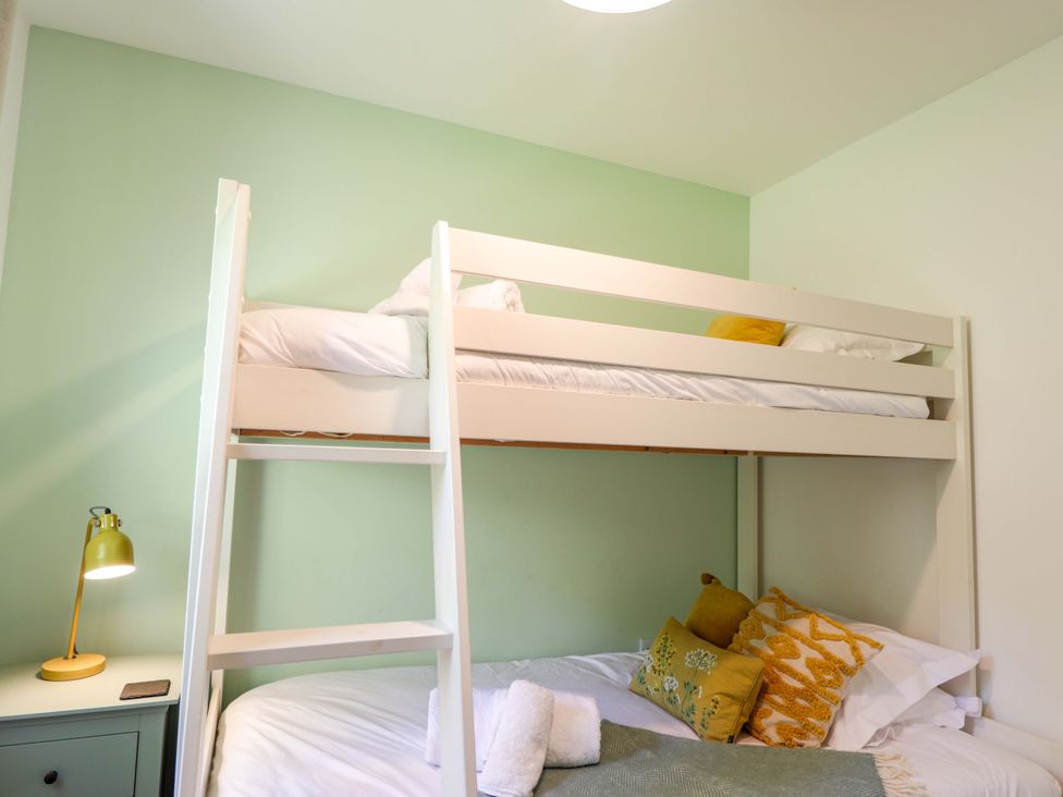 A bunk bed with bedding in a bedroom at The Lookout Saasaig near Broadford