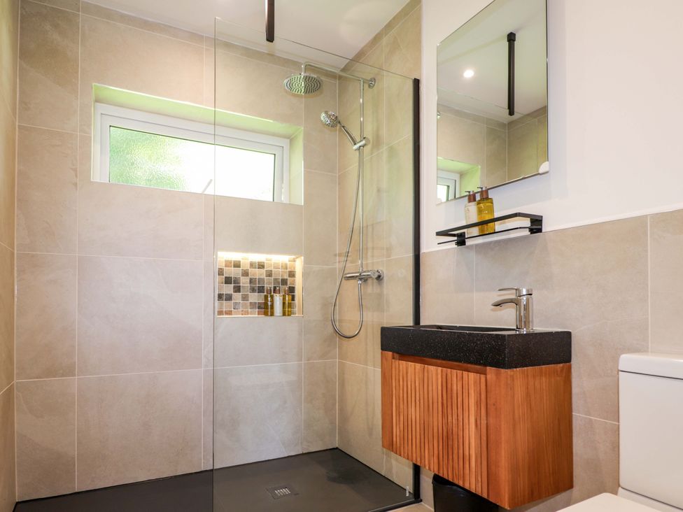 A bathroom with a sink, shower, and toilet at The Lookout in Saasaig near Broadford
